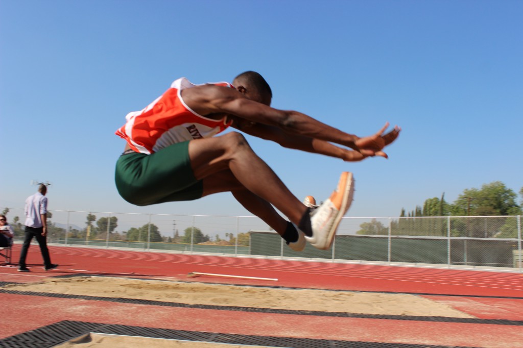 Brand Johnson (12) soars to new heights in the long jump.