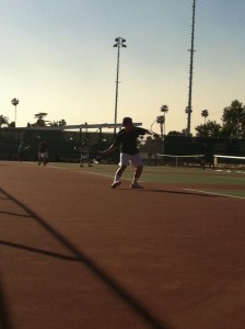 Nicholas Jacobs (11) swings a fore hand shot.